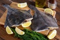 Raw fish flounder, flatfish on wood Royalty Free Stock Photo
