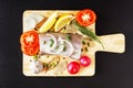 Raw fish meat, organic radish, lemon, onion and spice top view with closeup on cutting board. Fresh natural, organic, healthy and Royalty Free Stock Photo