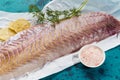 Raw fish with salt and dill on table Royalty Free Stock Photo