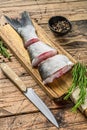 Raw fish silver carp sliced into steaks. wooden background. Top view
