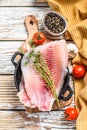 Raw fish telapiya in a pan. White wooden background. Top view