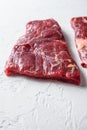 Raw Flap meat, London Broil organic meat cut side view close up over white concrete background vertical selective focus Royalty Free Stock Photo