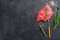 Raw Flat iron steak with rosemary and pink salt. Fresh Marble beef meat black Angus. Black background. Top view. Copy Royalty Free Stock Photo