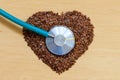 Raw flax seeds heart shaped and stethoscope Royalty Free Stock Photo