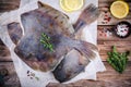 Raw flounder fish, flatfish on wooden table Royalty Free Stock Photo