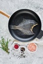 Raw flounder in the pan. Gray background, top view. Royalty Free Stock Photo