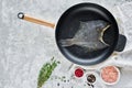 Raw flounder in the pan. Gray background, top view. Royalty Free Stock Photo