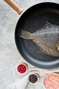 Raw flounder in the pan. Gray background, top view. Royalty Free Stock Photo