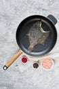 Raw flounder in the pan. Gray background, top view. Royalty Free Stock Photo