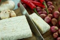 Cooking tempe preparation closeup with onion, garlic, red chili, tomatoes. Seasoned tempeh. Indonesian simple seasoning