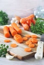 Raw food ingredients. Peeled chopped carrots, parsley and olive oil