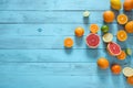 Raw food slicing and whole tropical citrus fruit on wooden blue background. Royalty Free Stock Photo