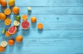 Raw food slicing and whole tropical citrus fruit on wooden blue background. Royalty Free Stock Photo