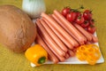 Raw frankfurter sausages and bread on plate Royalty Free Stock Photo