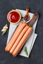 Raw frankfurter sausages with ketchup Royalty Free Stock Photo