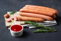 Raw frankfurter sausages with ketchup