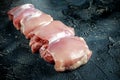 Raw Free range Boneless skinless chicken thighs on stone table