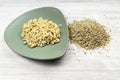 Raw freekeh wheat grains and boiled porridge