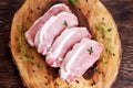 Raw Fresh Boneless Pork Chops with herbs. on wooden board. Royalty Free Stock Photo