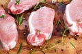 Raw Fresh Boneless Pork Chops with herbs. on wooden board. Royalty Free Stock Photo