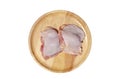 Raw fresh Chicken thighs on a wooden plate. isolated on white background with clipping path Royalty Free Stock Photo
