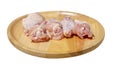 Raw fresh chicken wings on a wooden plate. isolated on white background with clipping path. side view Royalty Free Stock Photo