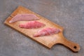 Raw red mullet fillets on a cutting board