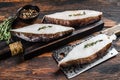 Raw fresh halibut fish steak on a wooden cutiing board. Black background. Top view Royalty Free Stock Photo