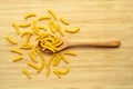 Raw fresh and healthy macaroni pasta on wooden spoon Royalty Free Stock Photo