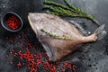 Raw fresh John Dory fish with pink pepper and thyme. Black background. Top view Royalty Free Stock Photo