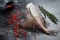 Raw fresh John Dory fish with pink pepper and thyme. Black background. Top view Royalty Free Stock Photo