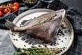 Raw fresh John Dory fish with pink pepper and thyme. Black background. Top view Royalty Free Stock Photo
