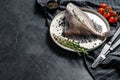 Raw fresh John Dory fish with spices and herbs for cooking. Black background. Top view. Copy space Royalty Free Stock Photo