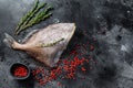 Raw fresh John Dory fish with spices and herbs for cooking. Black background. Top view. Copy space Royalty Free Stock Photo