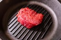 Raw, fresh, juicy marbled meat roast beef is ready to cook, on a grill pan with fluting. Royalty Free Stock Photo