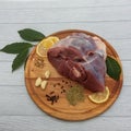 Raw fresh lamb meat with bone on a round wooden cutting board. Royalty Free Stock Photo