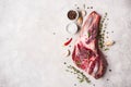 Raw fresh Lamb Meat leg and seasonings on gray concrete background Royalty Free Stock Photo