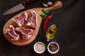 Raw fresh Lamb Meat ribs and seasonings on wooden cutting board. Royalty Free Stock Photo