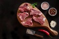 Raw fresh Lamb Meat ribs and seasonings on wooden cutting board. Royalty Free Stock Photo