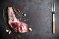 Raw fresh Lamb Meat shank, herbs and fork on black stone background Royalty Free Stock Photo