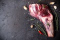 Raw fresh Lamb Meat shank and seasonings on black stone background Royalty Free Stock Photo