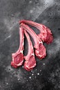 Raw fresh lamb ribs, on black dark stone table background, top view flat lay, with copy space for text Royalty Free Stock Photo