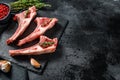 Raw fresh lamb ribs with pepper and rosemary. Organic meat. Black background. Top view. Copy space Royalty Free Stock Photo