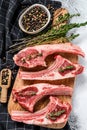 Raw fresh lamb ribs with pepper and thyme. Organic meat. White background. Top view Royalty Free Stock Photo