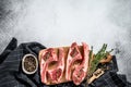 Raw fresh lamb ribs with pepper and thyme. Organic meat. White background. Top view. Copy space Royalty Free Stock Photo