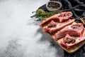 Raw fresh lamb ribs with pepper and thyme. Organic meat. White background. Top view. Copy space Royalty Free Stock Photo