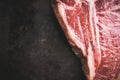 Raw fresh marble T-bone meat on the rustic background