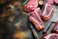 Raw fresh marbled meat Steak, seasonings, tomahawk, t bone, club steak, rib eye and tenderloin cuts, on old dark rustic background Royalty Free Stock Photo