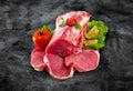 Raw fresh meat medallions with vegetables on black board and clipping path Royalty Free Stock Photo