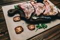 Raw fresh meat pork steak and seasonings on a dark wooden background board honey tomato board